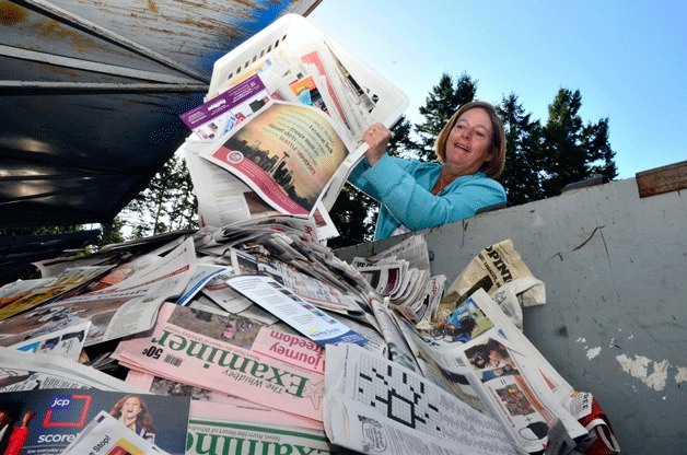 Greenbank resident Wendy Waitt dumps her recyclables at Island County’s facility in Coupeville. A curbside program is again being discussed for Island Disposal customers who live in rural county areas.