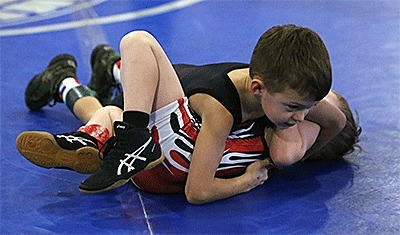 Ethan Hunsaker records a pin on the way to winning his weight division.