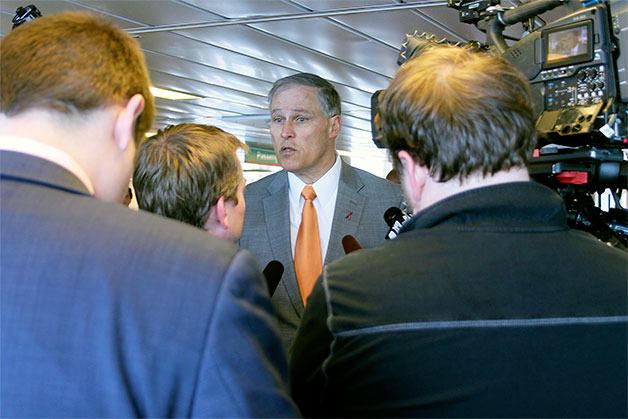 Gov. Jay Inslee talks to reporters about his proposed transportation package aboard the Tokitae Wednesday.