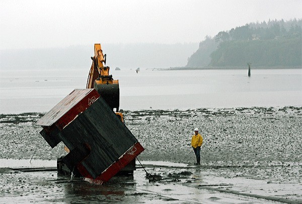 C. Johnson Construction workers prepare an area of the beach before making repairs to the Windjammer Park RBC wastewater treatment outfall pipe near the end of City Beach Street on Wednesday morning. Repairs were completed Thursday.