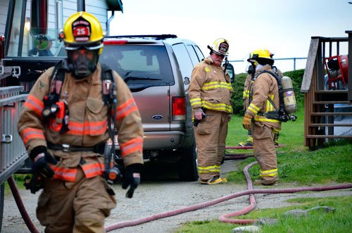 North Whidbey Fire and Rescue firefighters wrap up after extinguishing a kitchen fire in a West Beach Road home Tuesday evening.