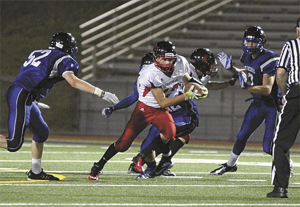 Josh Bayne (white jersey) weaves through the Bellevue Christian defense.