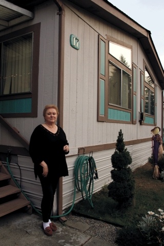 Jean Pattelle stands in front of her home at Evergreen Park off Goldie Road. If a land use designation change is adopted