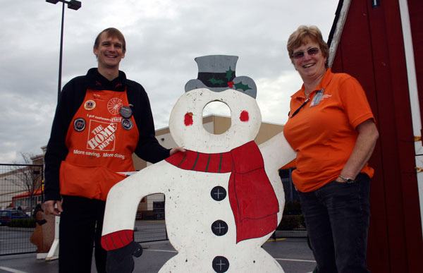 Aileen Kesler and James Croft set up for the Christmas Village at Home Depot. Any volunteers are welcome to paint