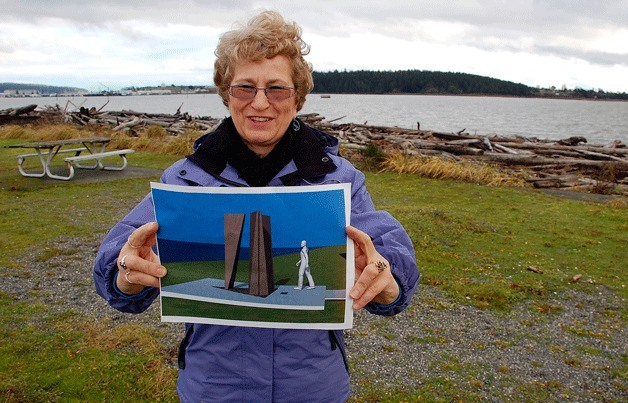 Oak Harbor resident Sue Karahalios holds up a conceptual drawing of an art piece that she hopes to have constructed on the waterfront at the end of City Beach Street. The piece would honor the city’s three founding fathers.