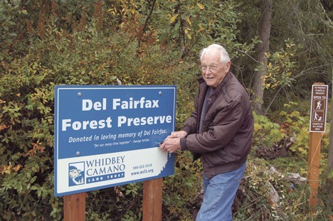 George Fairfax stands next to the sign marking the Del Fairfax Preserve