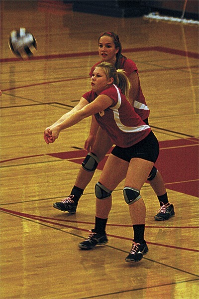 Madeline Strasburg passes for the Wolves as Bessie Walstad covers in the win over Granite Falls.