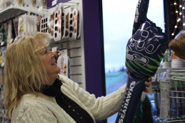Peggy Burton shops for Seahawks items at the Whidbey Party Store in Oak Harbor last week.