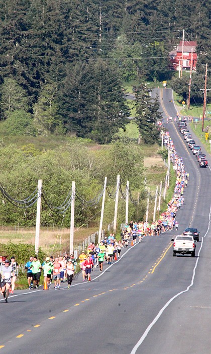 Runners of the half marathon steam down Crescent Harbor Road in last year’s race.