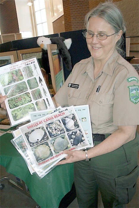 Interpretive specialist Tina Dinzi-Pederson holds out the “critter cards” that were the result of a 2008 WSU Camano Island Beachwater class project.