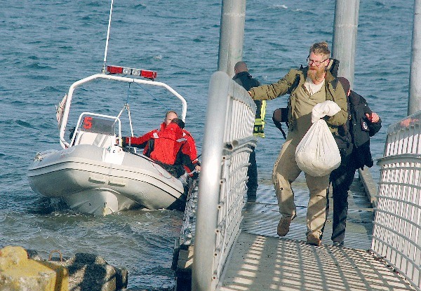 Peter Driftmeyer steps ashore Monday after being rescued from his sailboat near the Coupeville boat launch. The 46-year-old had been stranded on his vessel since Saturday evening.