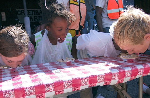 Loganberry Festival attendees participate in the annual pie eating contest at the 2013 event.
