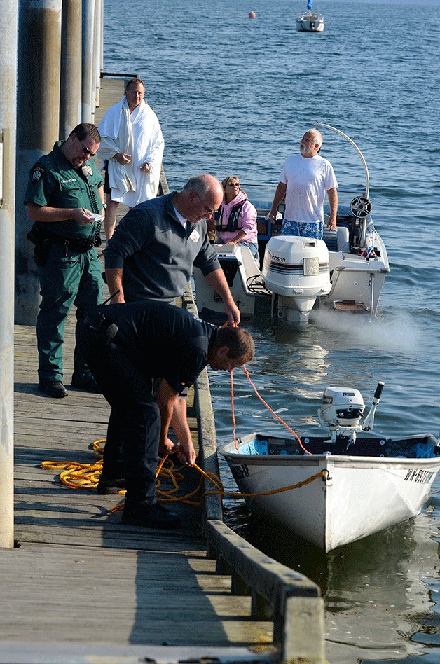 Emergency responders help tie up Chuck Maddox’s boat