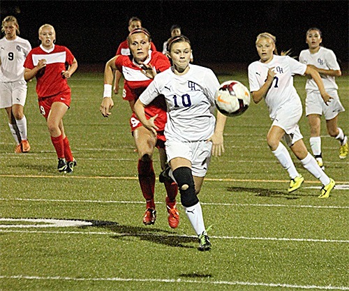 Mary Johnston (10) chases down the ball in Oak Harbor's match with Stanwood Thursday.