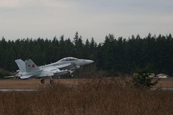 An EA-18G Growler performs a touch and go at Outlying Field Coupeville