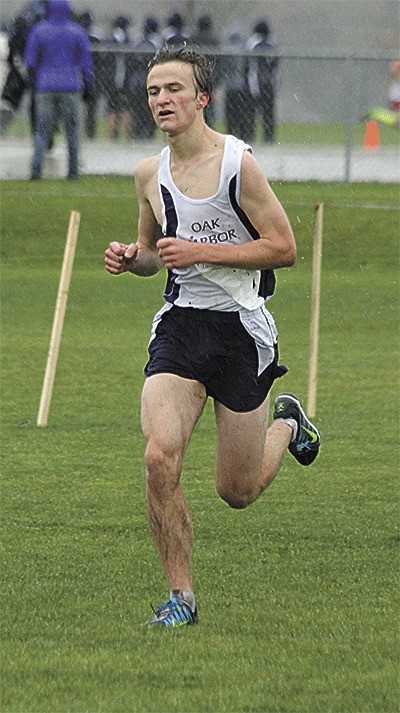 Clayton Richardson slogs through the rain at district on the way to earning a berth in the state cross country meet.