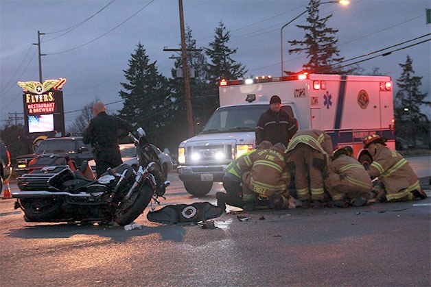 Oak Harbor Fire Department personnel stabilize the motorcyclist for transport to Whidbey General Hospital Tuesday morning.