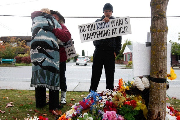 Vicki Morse (center left) is comforted by Merry Pickering (left) at a memorial for Keaton Farris to mark the 6-month anniversary of his death from dehydration at the jail in Coupeville on Wednesday