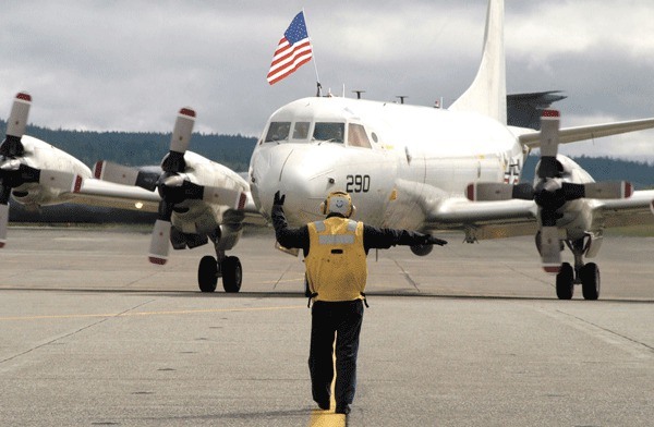 A P-3 Orion is guided on the tarmac at Whidbey Island Naval Air Station. Admiral Gary Roughead