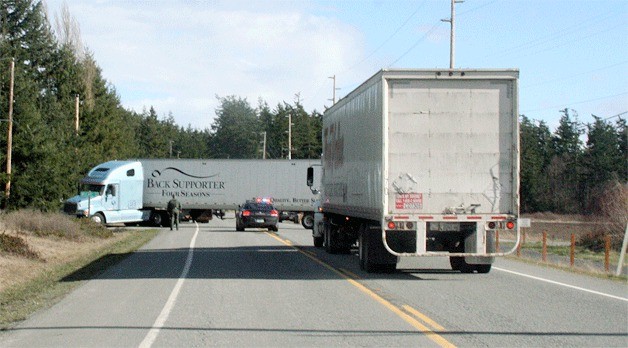A semi truck blocks both lanes of Highway 20 south of Coupeville Wednesday afternoon. The driver got stuck after trying to make a U-turn.