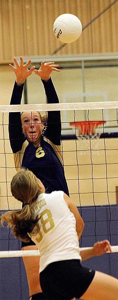 Oak Harbor's Hailee Blau blocks Lynnwood's Desiree Graham in the Wildcats' win Thurday.