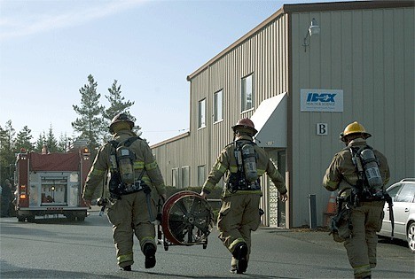 Oak Harbor Fire Department and North Whidbey Fire and Rescue pesonnel respond to a fire alarm at IDEX Health and Science on Friday morning. The teams used several ventilation fans to clear smoke from the building. The cause of the smoke was unavailable at press time.