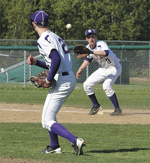 Oak Harbor pitcher Grant Schroeder throws to first baseman David Kusnick after fielding a comebacker against Shorewood.
