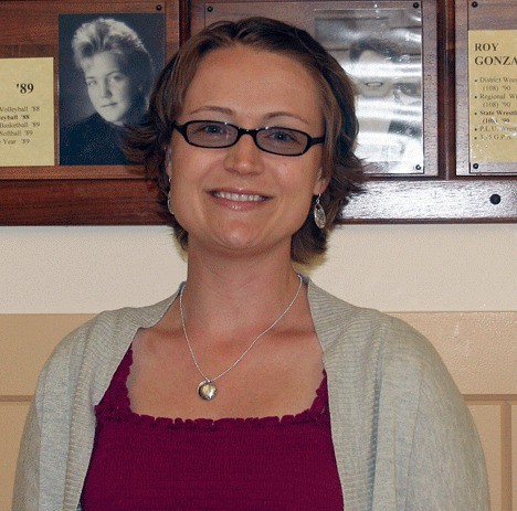 Teacher Nicola Wethall stands in front of the Wall of Fame at Oak Harbor High School.  She recently received the “Presidential Award for Excellence in Mathematics and Science Teaching”.