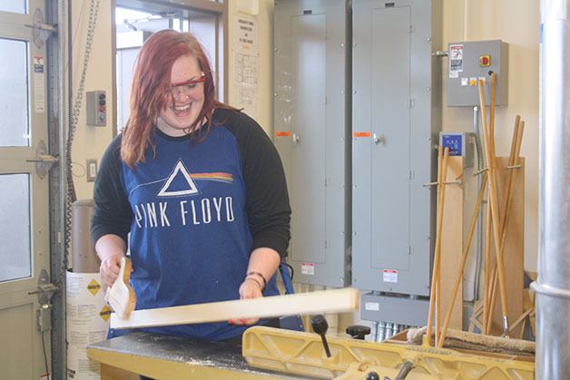 Oak Harbor High School senior Chelsea Lang cuts wood in her woodworking class. Lang is one of the female students in the Career and Technical Education program.