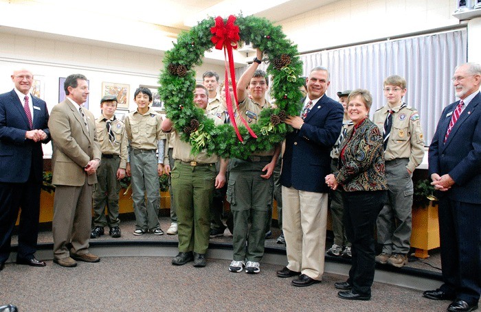 Tyler Collins and Chris Cloo of Boy Scouts of America Troop 4059 hold up a wreath that was presented to the Oak Harbor City Council and Mayor Jim Slowik earlier this month.