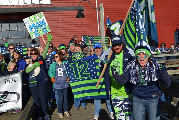 Fans show their support of the Seahawks during a rally on the Coupeville Wharf last January. Another Seahawks rally on the wharf will be held Sunday