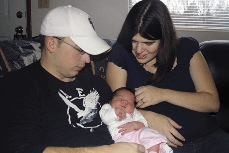 Parents Tegan and Garett Clements hold four-day-old Aiyana
