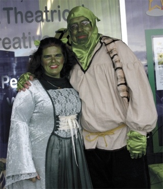 Executive directors Rebekka Handschke and Scot Ratzlaff dress as the princess and Shrek for their free Halloween makeup workshop.