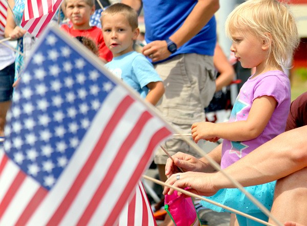 Young parade goers wait for candy to be tossed during Oak Harbor’s Fourth of July parade last summer.