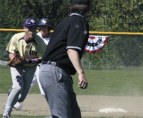 Oak Harbor shortstop Brent Mertins scoops up a slow roller and gets ready to fire to first.