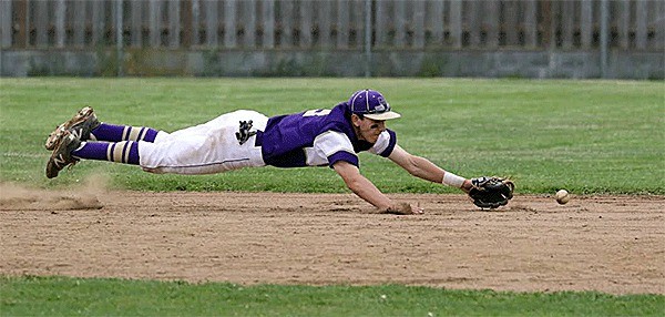 Wildcat shortstop Brent Mertins dives for a ground ball in Oak Harbor's win Tuesday.