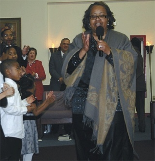 Pastor Fannie Dean of Unity Fellowship leads the choir in the song “Oh Happy Days
