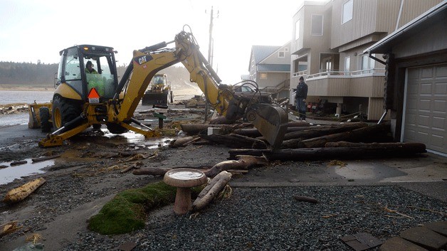 Workers clear West Beach Road. The stretch of West Beach Road between Swantown and Even Down Way was shut down most of Monday.