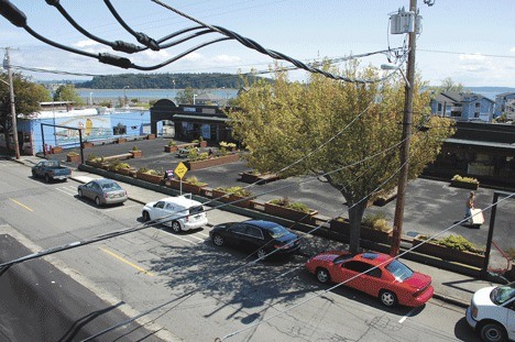 Power lines from the roof of Jo Jo’s Harbor Light Tavern in Oak Harbor run across Pioneer Way. The city may bury the lines underground as part of the road project.