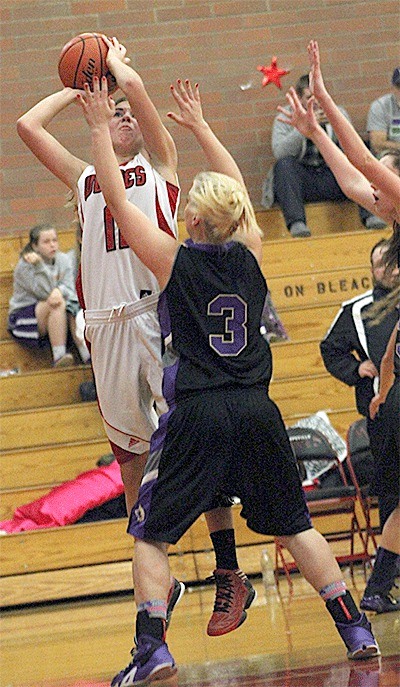 Julia Myers shoots over the defense of Sequim's Hailey Lester.