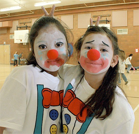 Ten-year-olds Naomi Garcia and Malia Hansen show off their clown makeup