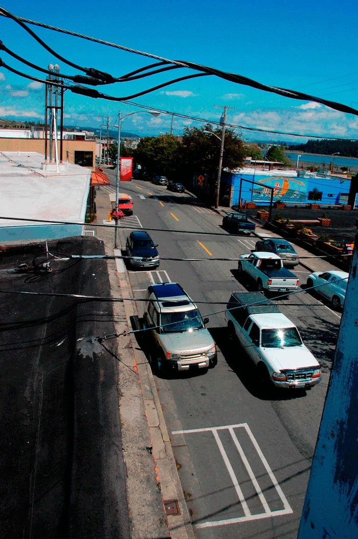 Utility lines criss-cross SE Pioneer Way. Although the city is planning to bury all the lines as part of the street’s improvement project