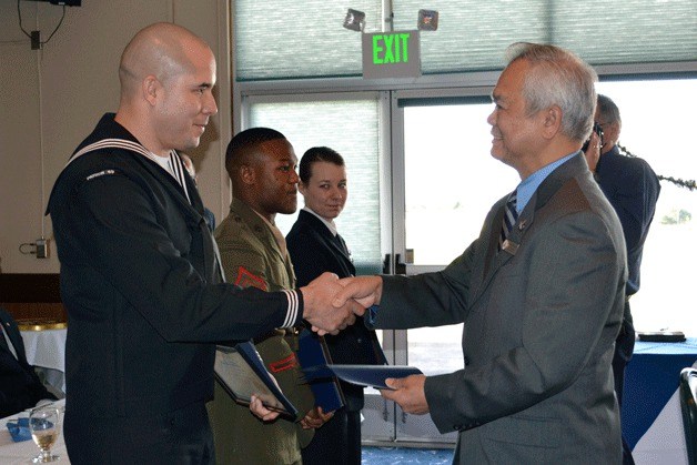 Oak Harbor Mayor Pro Tem Danny Paggao congratulates Sea Sailor of the Year AWF1(NAC/AW) David Smith during a luncheon at the Officers’ Club on NAS Whidbey Island Friday