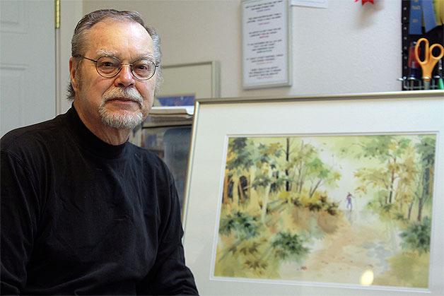 Randy Emmons stands in his North Whidbey home studio before a watercolor painting that was selected for the 75th Annual International Open Exhibition in Seattle. He is one of 86 artists picked for the exhibit out of 600 entries from seven countries.