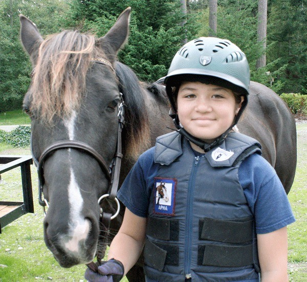 Ten-year-old Cassandra Pfannenstiel enjoys jumping her horse