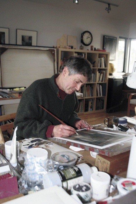 Richard Nash works on a painting in his 400-square foot studio on Green Road.