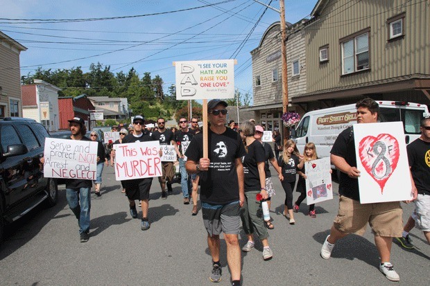 Fred Farris leads more than 250 protesters along Front Street in Coupeville on Father’s Day. The crowd gathered to protest the death of his son