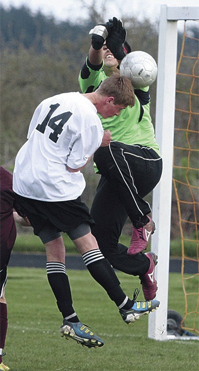 Coupeville's Jeremy Copenhaver meets Lakewood's Gustavo Garcia at the goal in the Wolves' win Monday.