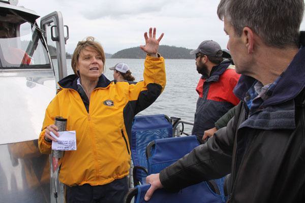 North Whidbey resident Dawn Glavick shares with others how she's happy with the beach restoration work at Ala Spit County Park during a boat tour of shoreline restoration projects coordinated by the Island County Department of Natural Resources April 29