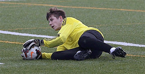 Jared Hoyt makes a diving save for Oak Harbor in its season-opening match with Anacortes.